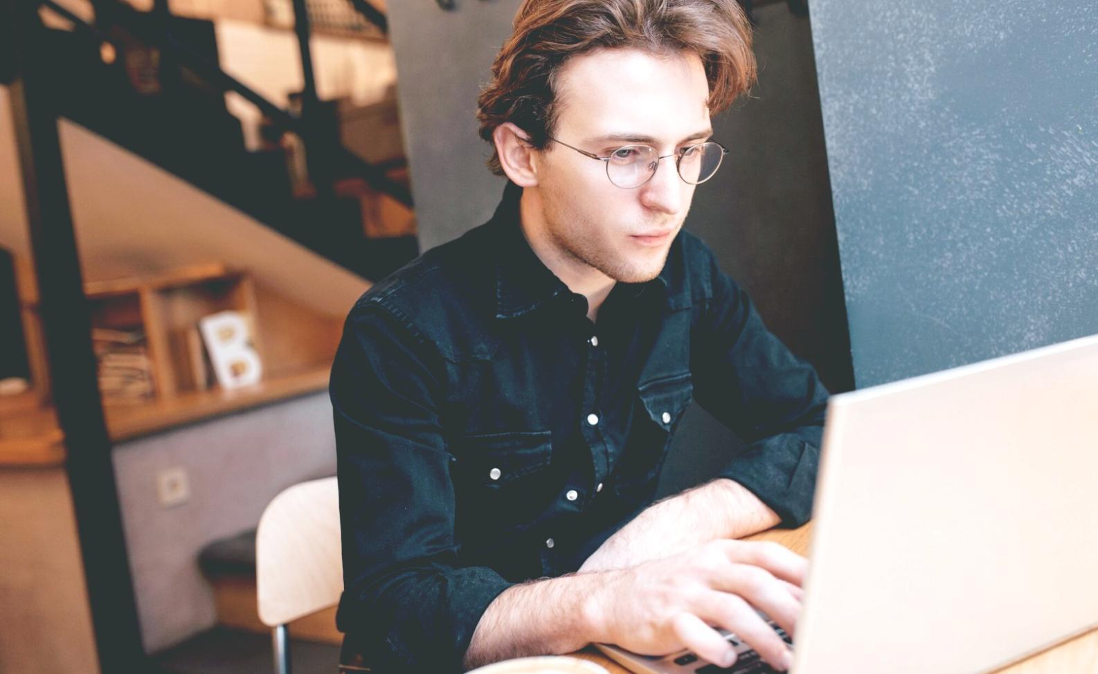 Modern game development workspace with multiple monitors showing code and game design elements